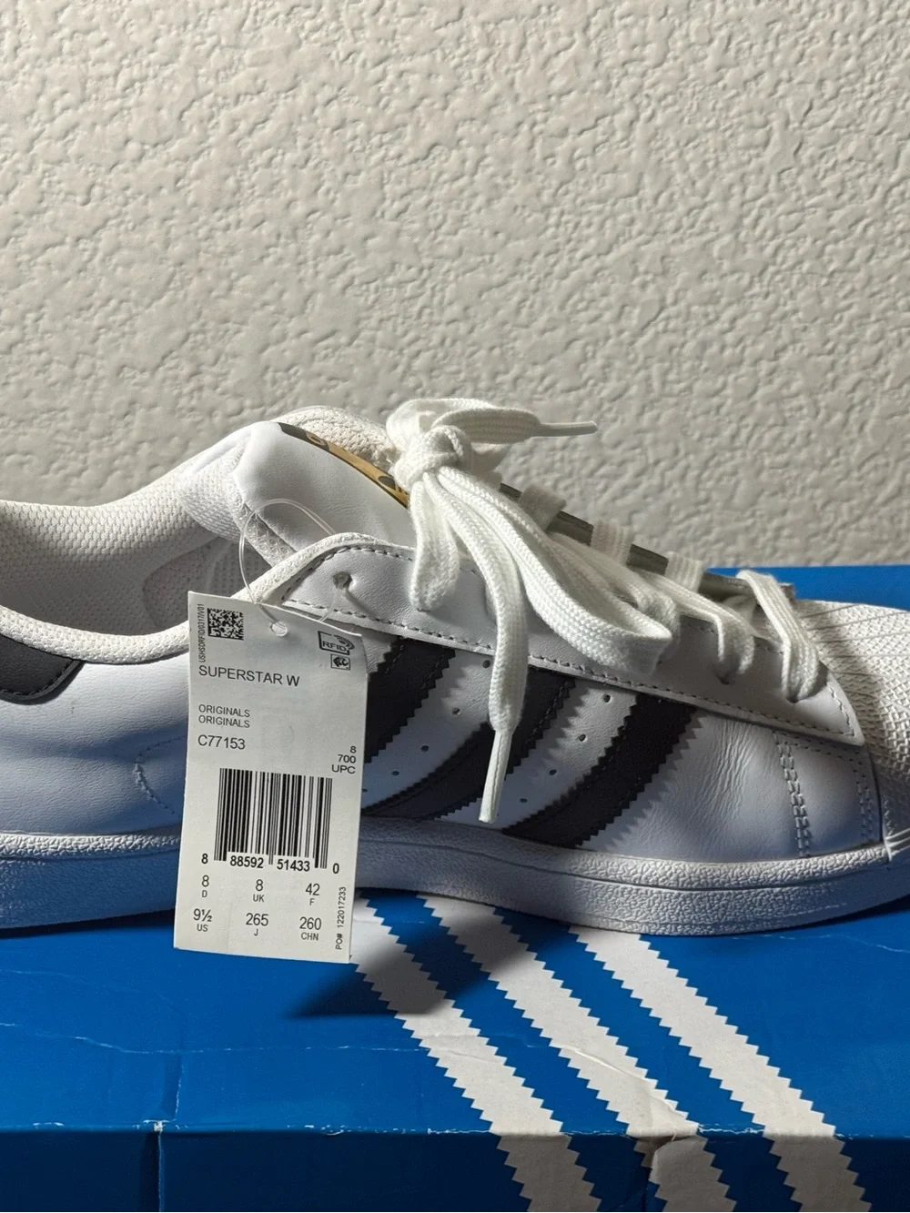 Adidas Superstar Sneakers with Black Stripes and Gold Tongue Logo